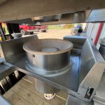 underside view of stainless steel ibc container being lowered onto discharge station
