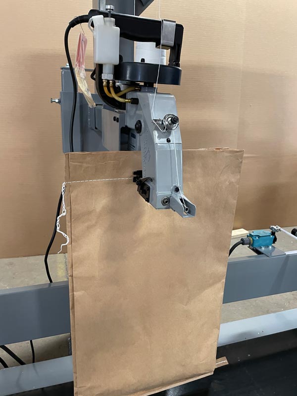 bag sewing machine for closing bags of deer corn and other grains