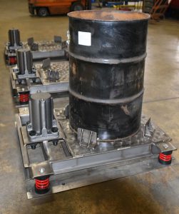 air powered vibrating tables settle sludge solids in 55 gallon drums