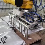 palletizing robot stacking bags of livestock feed pellets