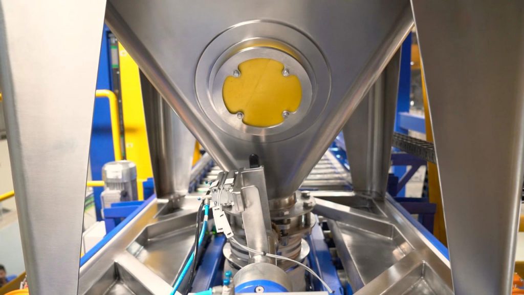 Intermediate bulk container or bin with mallet strike zone to free stuck battery powders