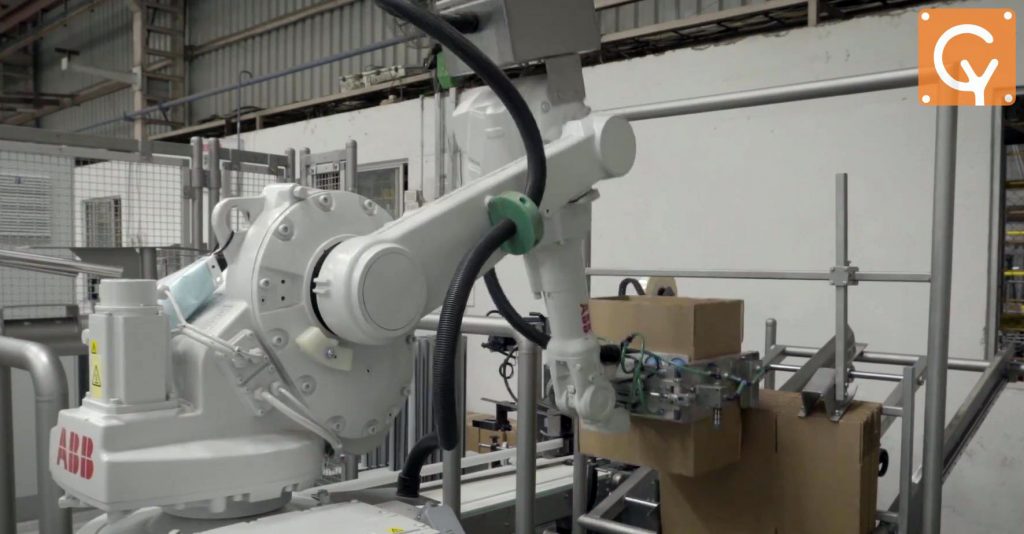 Robotic arm case erector or box builder picking up an empty box and unfolding it