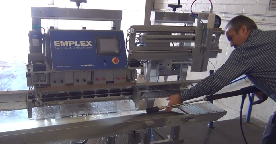 washing down a continuous band sealer using a power washer