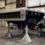 Large Enclosed Vibratory Feeder to Meter Large Aggregate into a Roll Mill for Size Reduction