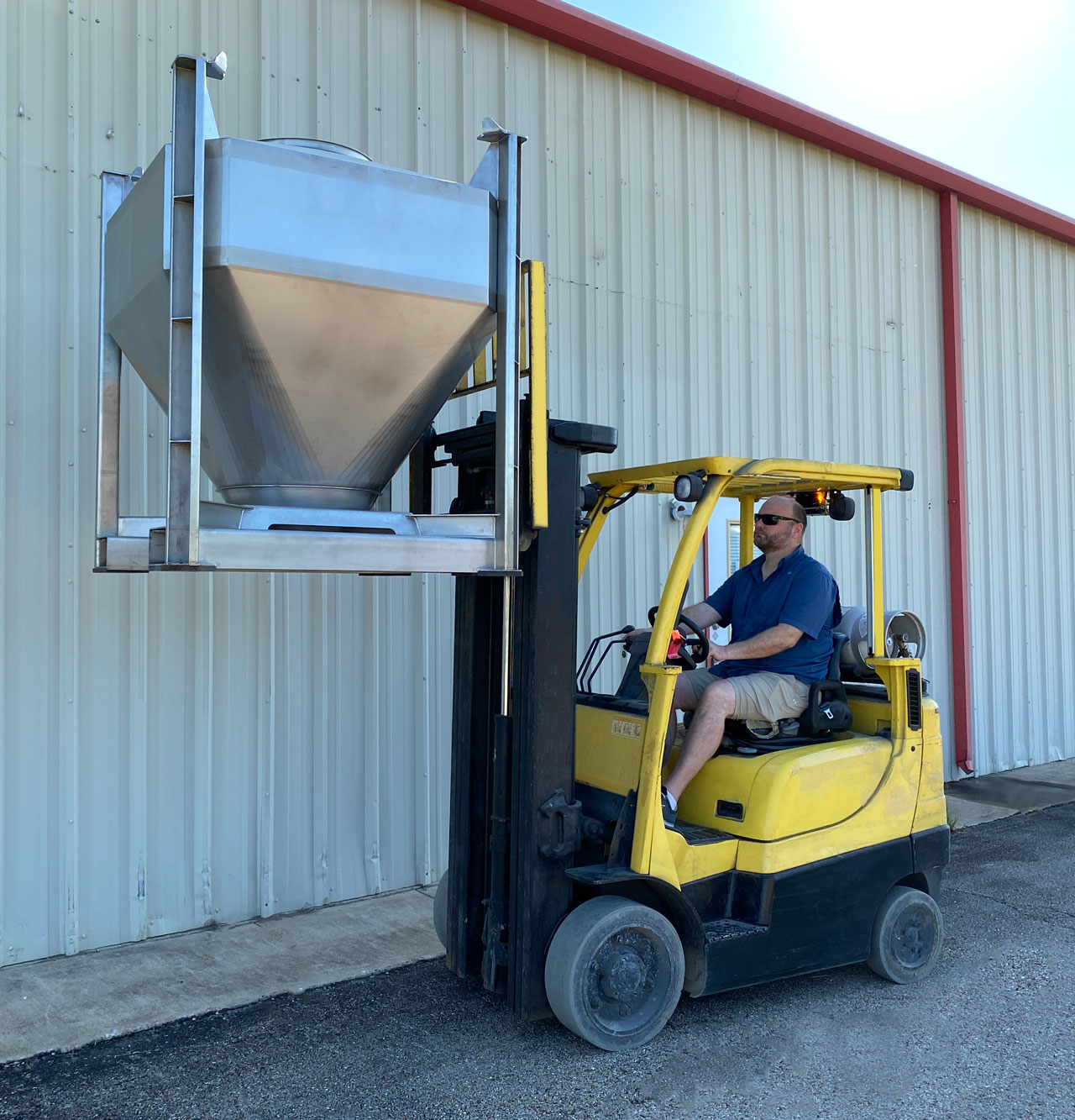 ibc container being raised by forklift