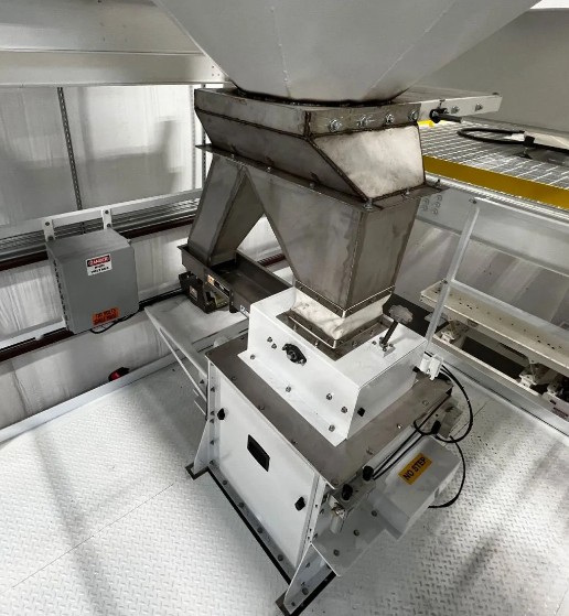 Net weigh bag filler with vibratory feeder and gravity gate