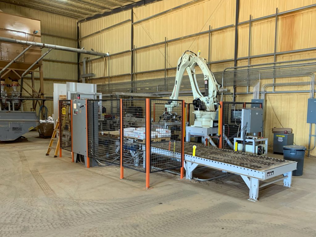 Full system view of small footprint valve bag filling system with robotic palletizer 