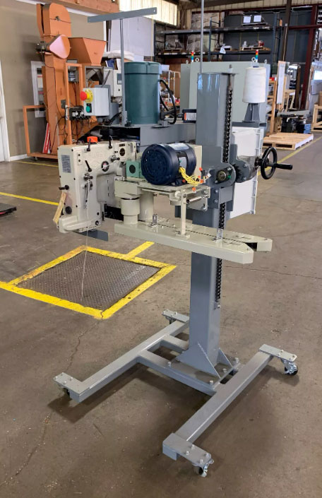 union special bag sewing head mounted on sewing pedestal with power infeed