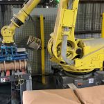 fanuc robot picking up 100 lb. bag of minerals using a bag gripper tool
